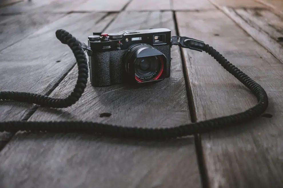 leica m1 camera on a wooden bench