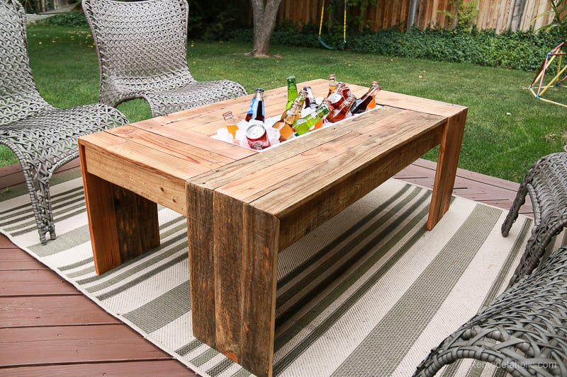 a coffee table from recycled wood withholding cold-drinks 