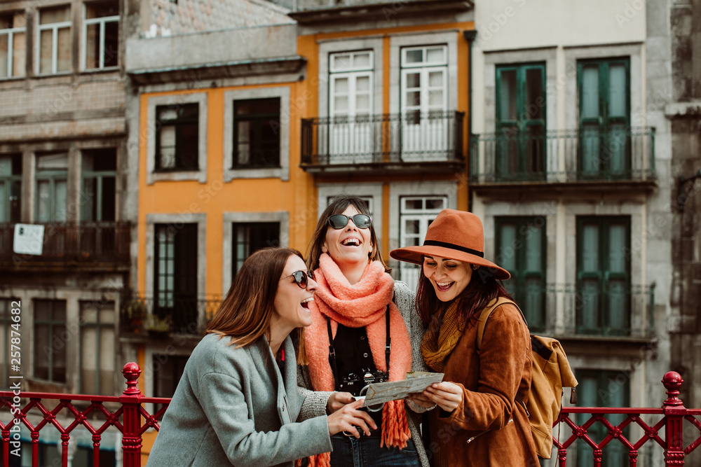 Women travelers looking at the map